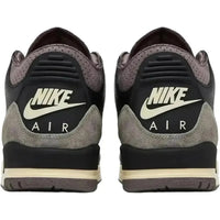 Rear view of black and violet ore Jordan 3 A Ma Maniére sneakers with Nike Air branding and premium suede heel overlays.