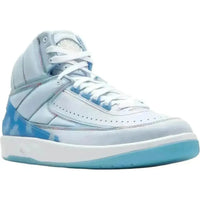 Light blue J Balvin x Air Jordan 2 high-top sneaker with cloud heel graphics, rainbow stitching, and white laces.
