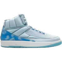 J Balvin Air Jordan 2 in light blue with cloud heel graphics, rainbow stitching, and a white midsole on a white background.