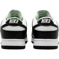 Back view of Nike Dunk Low Next Nature Panda women's sneakers featuring black and white leather with embroidered Nike heel logos.