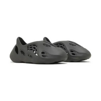 Adidas Yeezy Foam RNR Carbon in a sleek, one-piece black foam design with strategic perforations for breathability.